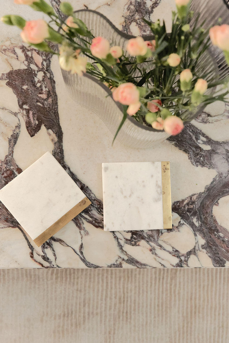 Flat lay of marble, stone and floral material samples by Carolina Ghigonetto