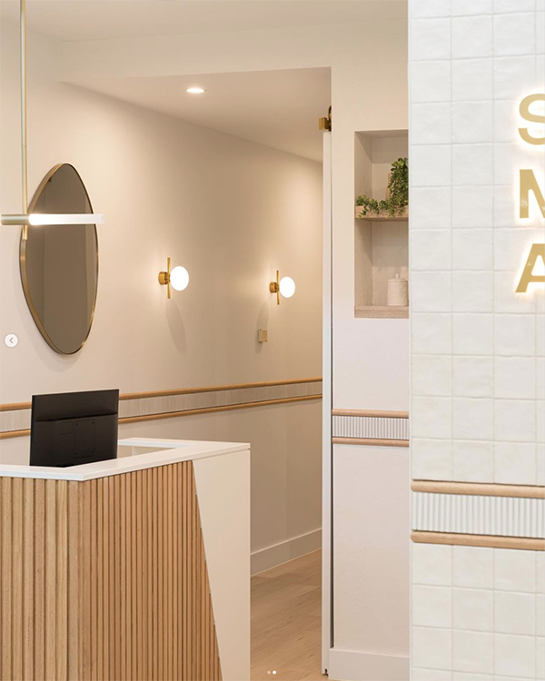 Retail interior render with a round mirror and timber counter by Ishoa Scozzafava