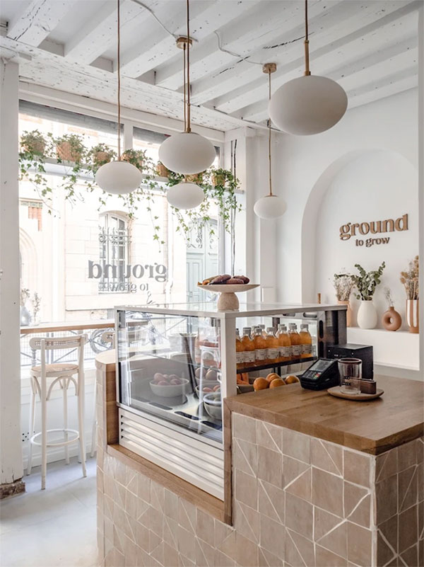 Café interior with hanging plants and timber counter by graduate Agathe Corbet