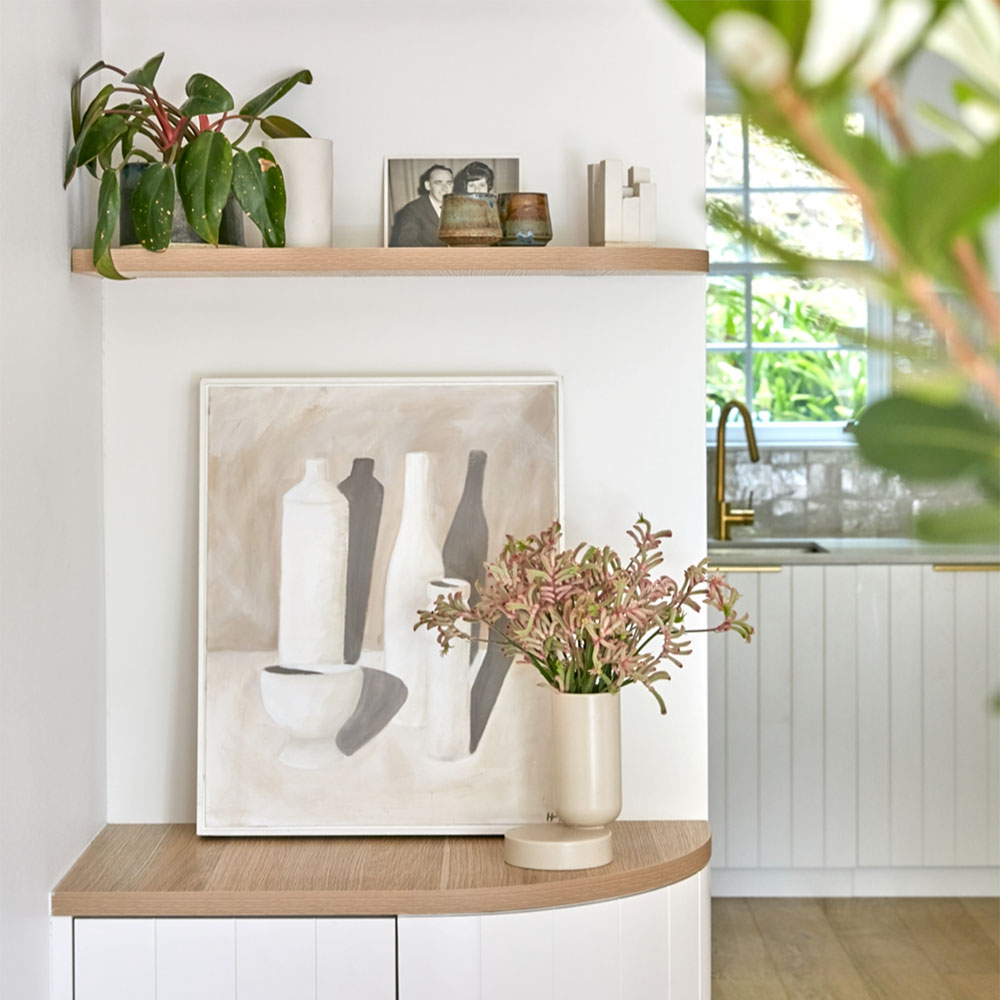Styled floating shelf with artwork and dried flowers by Anna McMillan