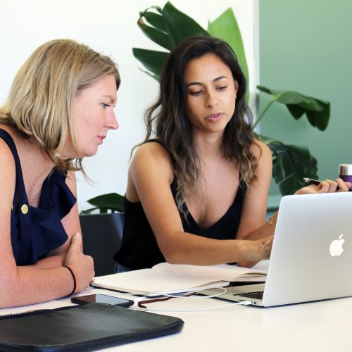 Dione Fague, Sydney Design School educator, working with a student on a laptop