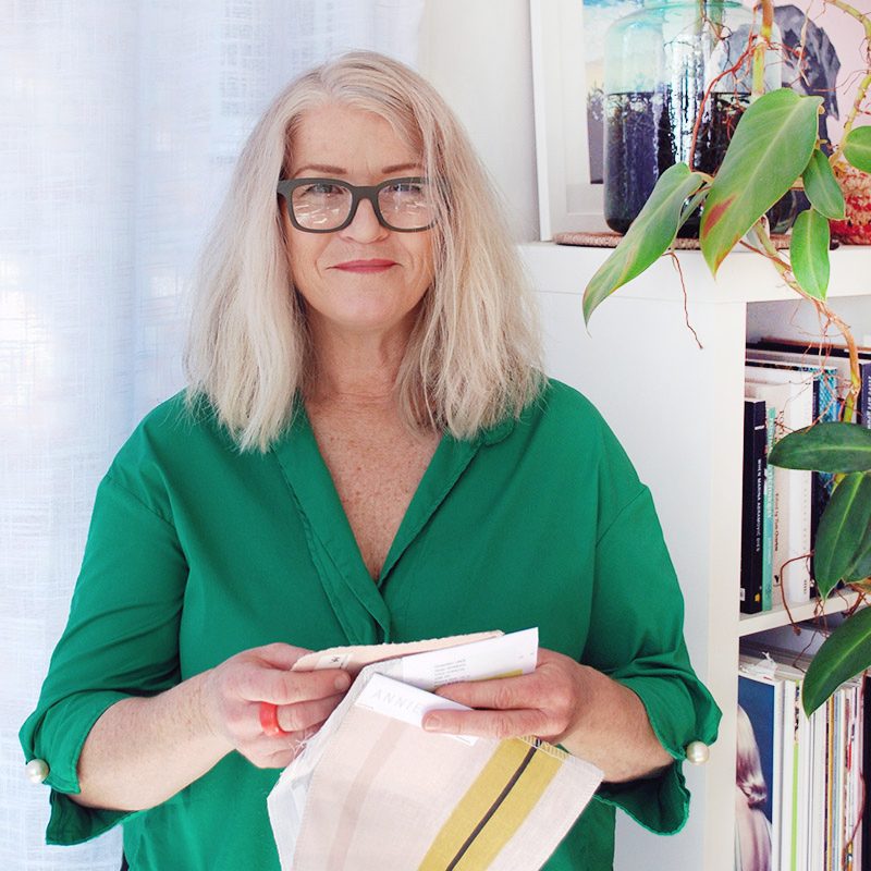 Donna Eddie, career changer and interior design student, holding samples