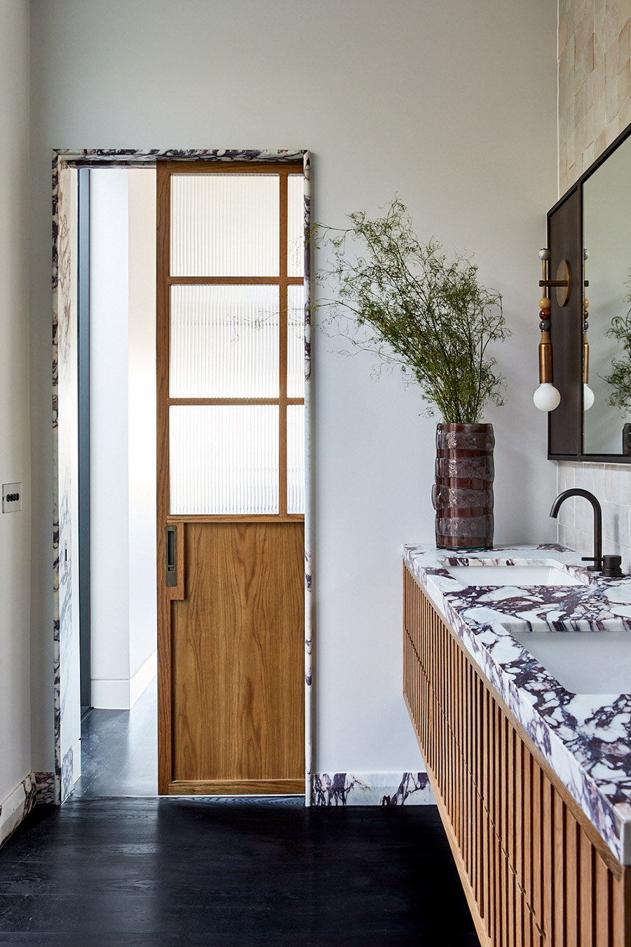 Bronte bathroom with timber door and marble vanity by Jillian Dinkel Designs