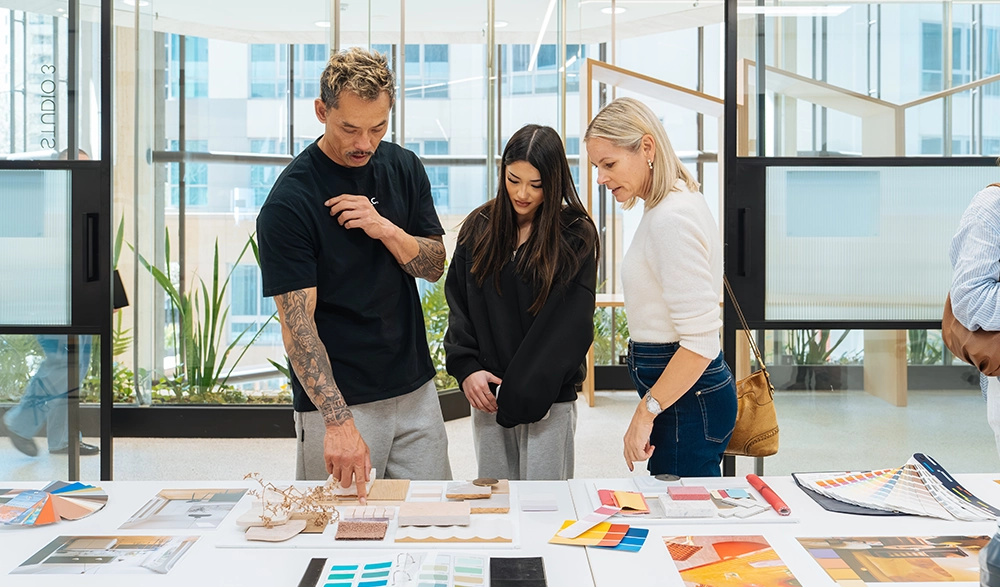 Tutor showing student work to visitors at a Sydney Design School open day
