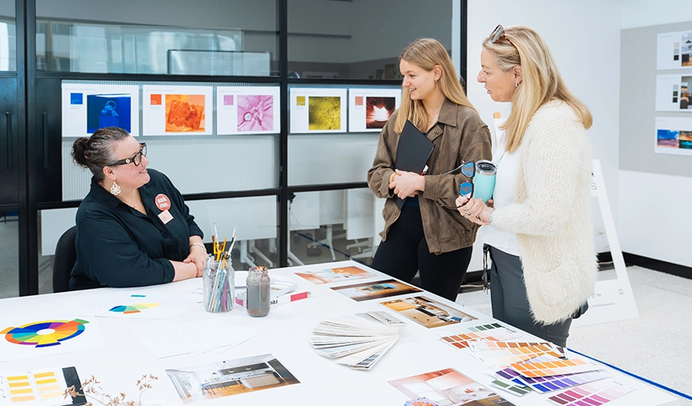 Visitors browsing colour and sample boards at a Sydney Design School open day