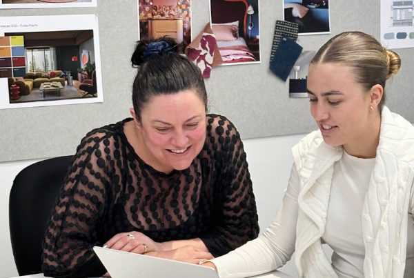 Tutor helping a student on a laptop in a Sydney Design School studio