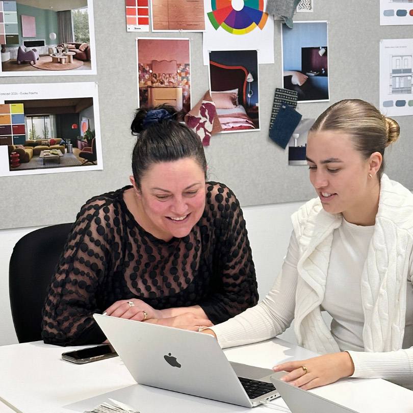 Tutor helping a student on a laptop in a Sydney Design School studio