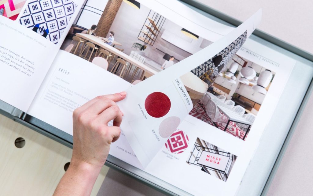 Hand marking up a printed InDesign interior design presentation
